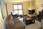 Mammoth Condo Rental Aspen Creek 117: Living Room with queen sofa sleeper, wood burning fireplace, large bright windows